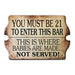 Vintage-style sign with humorous bar policy text on a white background