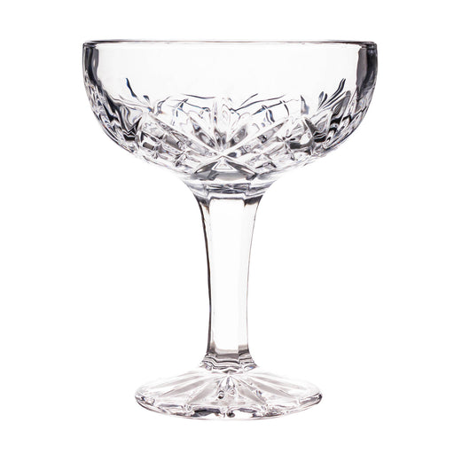 Clear glass coupe with intricate cut design on a white background