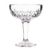 Clear glass coupe with intricate cut design on a white background