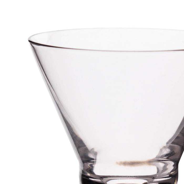 Clear glass cocktail glass on a white background