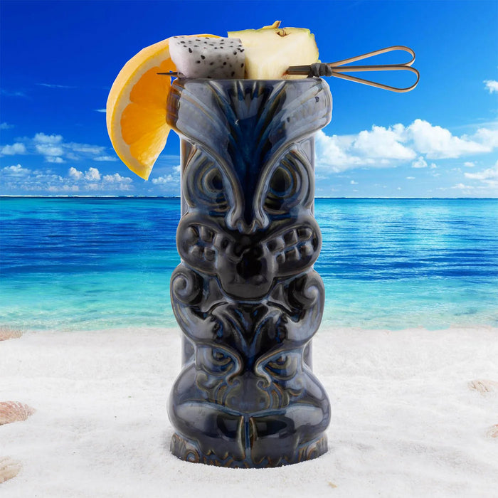 Decorative tiki mug with fruit on a beach with ocean view