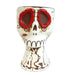 Ceramic skull mug with red eyes on a white background