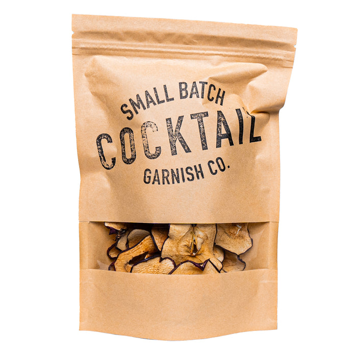 Kraft paper bag with 'Small Batch Cocktail Garnish Co.' text and cocktail garnishes inside.