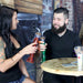 Two people sitting at a table with drinks in a casual setting