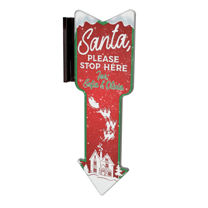 Christmas-themed sign with 'Santa, Please Stop Here' text on a red background