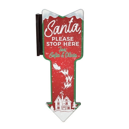 Christmas-themed sign with 'Santa Please Stop Here' text on a red background