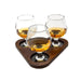 Three sniffer glasses on a dark walnut wooden tray with a white background