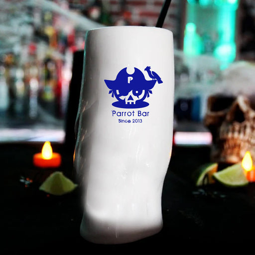 White cup with blue logo and text 'Parrot Bar Since 2013' against a blurred bar background.