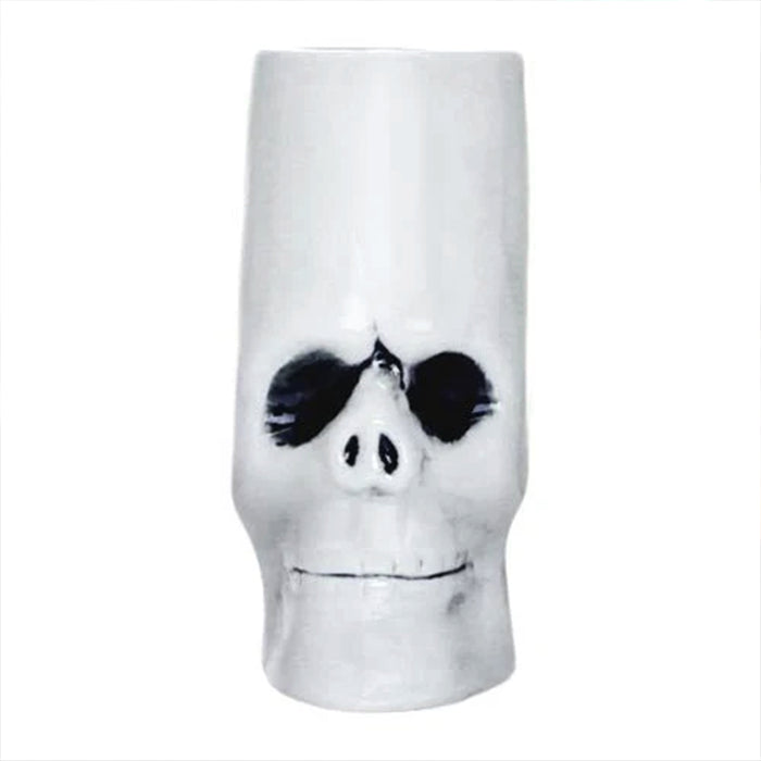 Skull-shaped mug with black eye sockets on a white background