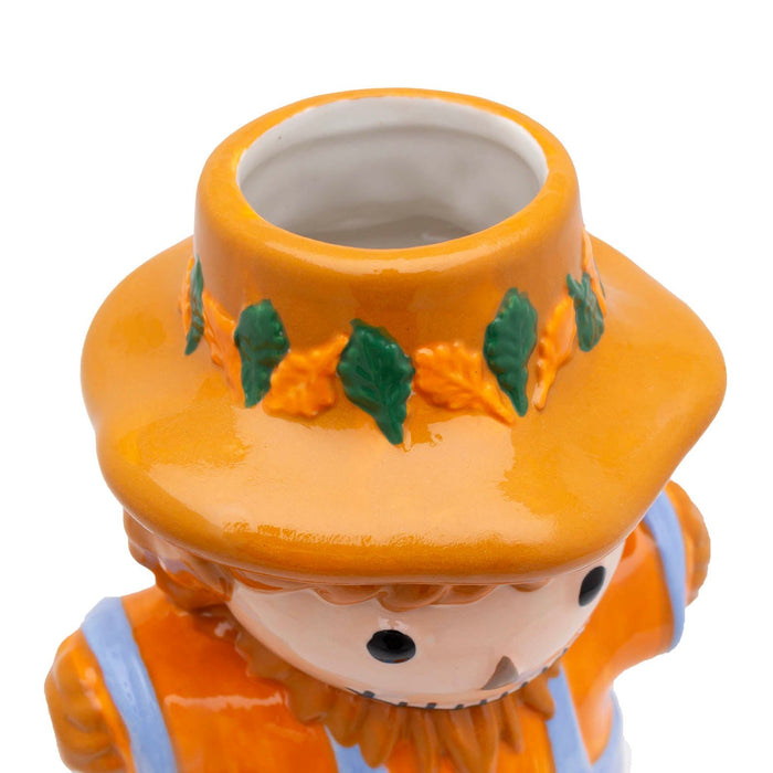 Ceramic scarecrow tiki mug with an orange hat and outfit on a white background
