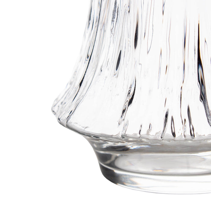 Close-up of a clear glass with textured surface on a white background