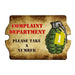 Sign with a green grenade and text 'Complaint Department Please Take A Number' on a brown background