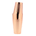 A polished copper cocktail shaker with a textured, diamond-patterned grip, shown stacked with two matching tumblers on a solid white background.