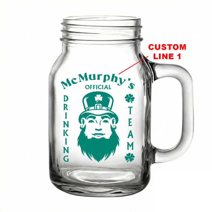 Clear glass mug with a design of a leprechaun and text 'McMurphy's Official Drinking Team' on a white background.