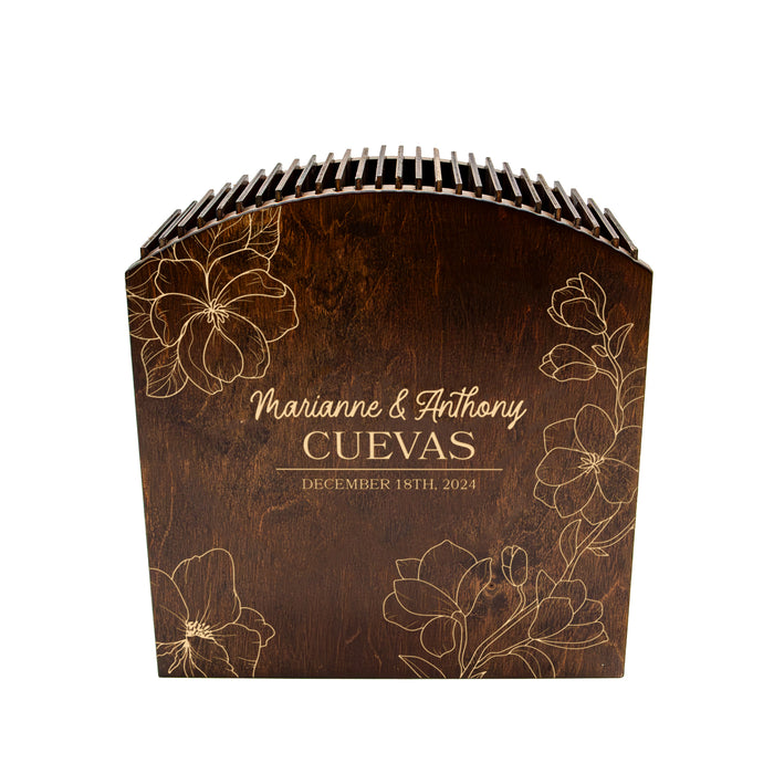 Wooden wedding album with floral designs and engraved text on a white background