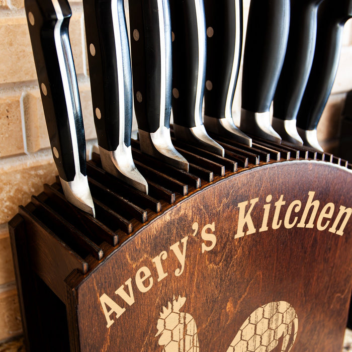 Set of knives in a wooden block with 'Avery's Kitchen' branding.