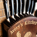 Set of knives in a wooden block with 'Avery's Kitchen' branding.