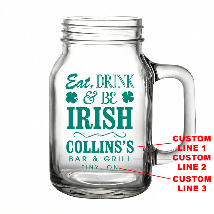 Clear glass mug with 'Eat, Drink & Be Irish' text and customizable lines on a white background