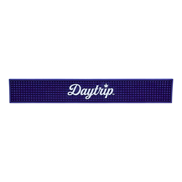 Blue bar mat with 'Daytrip' logo on a white background