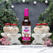 Bottle of Skinny Mixes gingerbread syrup with gingerbread man-shaped containers in a festive setting.
