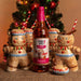 Bottle of Skinny Mixes Gingerbread flavor drink with gingerbread man-shaped cups in front of a Christmas tree.