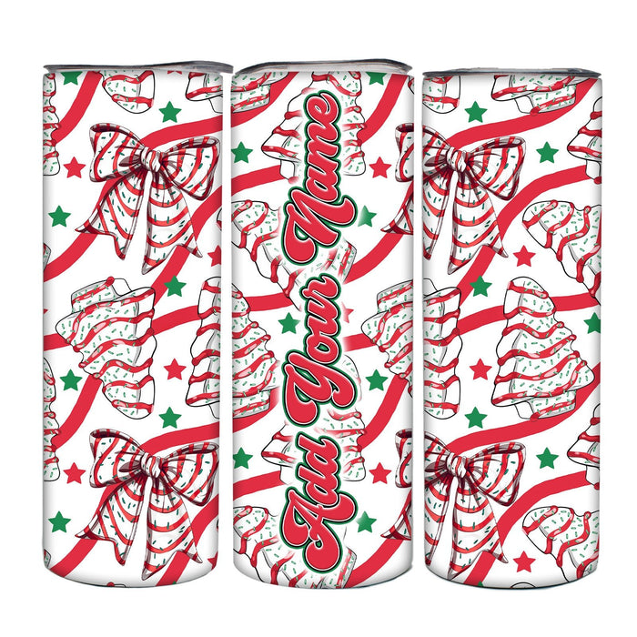 Three cans with festive Christmas design featuring bows, candy canes, and trees on a white background.