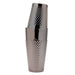 A polished silver metal cocktail shaker with a textured, diamond-patterned grip, shown stacked on a solid white background.