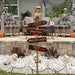 Halloween outdoor scene with skeletons, pumpkins, and a signpost on a patio.