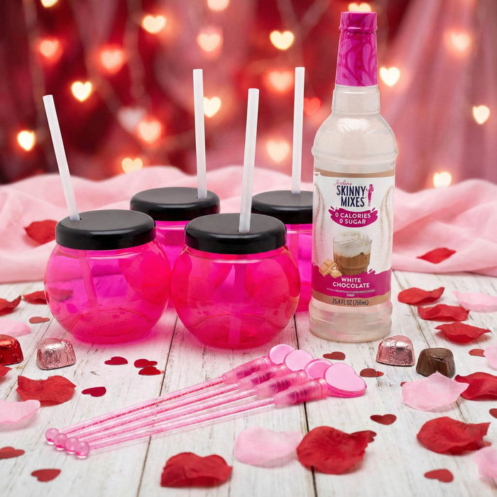 Skinny Mixes White Chocolate syrup bottle with pink cups and straws on a festive background.