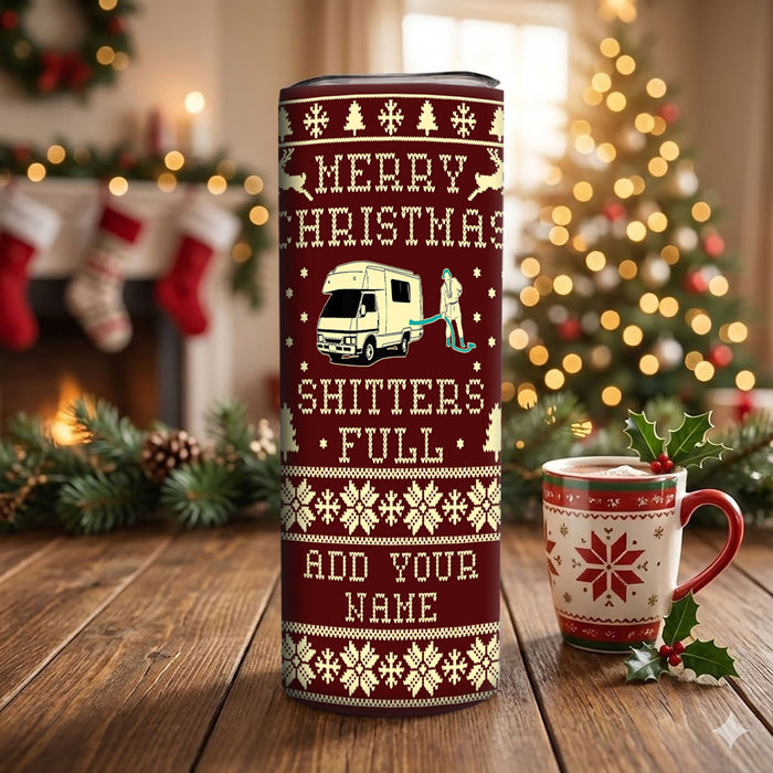 Christmas-themed tumbler with a festive design and a mug on a wooden surface.