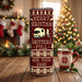 Christmas-themed tumbler with a festive design and a mug on a wooden surface.
