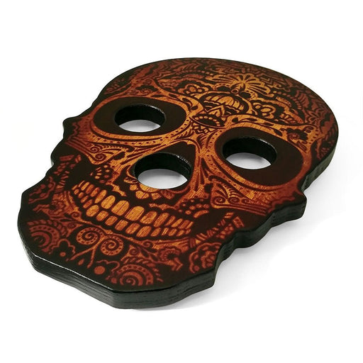 Decorative skull-shaped object with intricate patterns on a white background