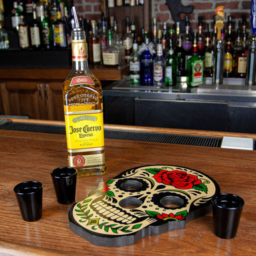 Jose Cuervo bottle with a skull-shaped shot glass holder on a bar counter.