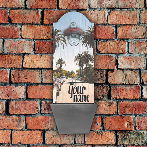 Decorative wall clock with palm tree design on a brick wall