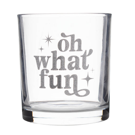 A clear glass rocks tumbler with a silver glittery etched design that reads 'oh what fun' with small star accents, shown on a plain white background.