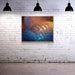 Colorful abstract painting on a white brick wall with three black pendant lights.